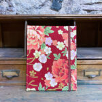 Notebook. Japanese floral pattern golden motifs red background.