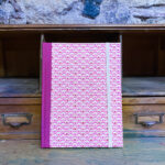 Notebook. Paper with fuchsia fabric spine. Traditional Japanese pattern Renji pink color. 