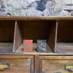 Assorted minibooks (Pack of 2). Golden print over red and black background.